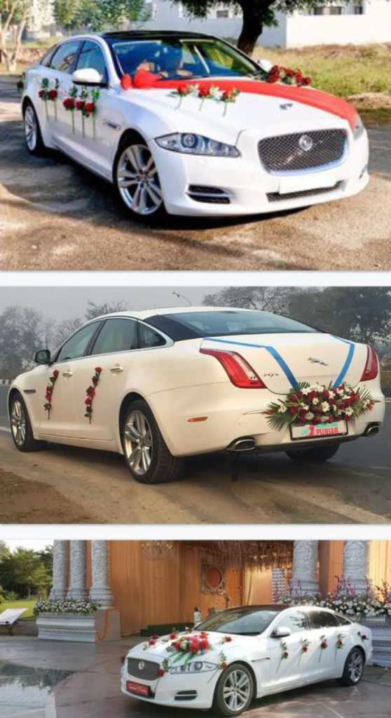A gleaming Jaguar XF wedding car adorned with cascading floral arrangements and ribbons, radiating elegance and luxury. Perfect for a fairytale wedding. Book your IndiaTaxi wedding ride today!