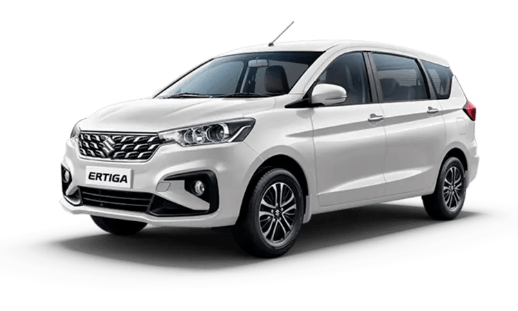 Photo of a compact Suzuki Ertiga car with a rooftop carrier, parked in a scenic location in Western India.